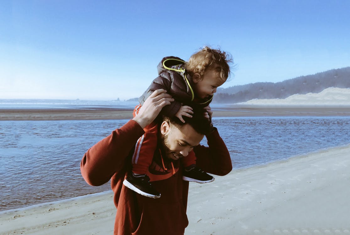 Dad visiting a beach with his young son
