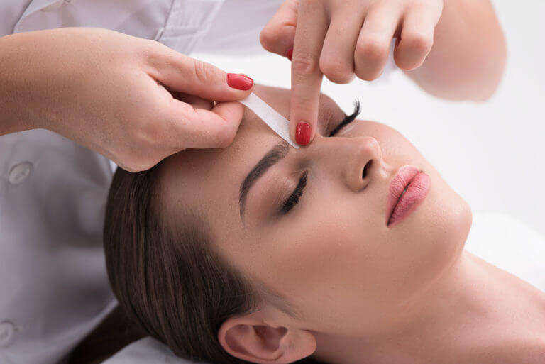 woman getting eyebrows waxed